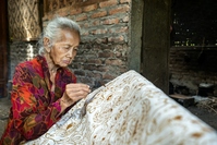 Woman drawing traditional batik pattern, Yogyakarta, Java
