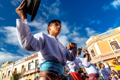 Man dancing in the parade at a festival in Riobamba, Ecuador