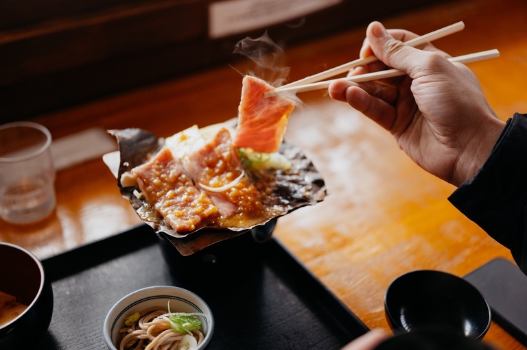 Grilling Hida beef on hoba miso in a Japanese restaurant, Takayama, Japan